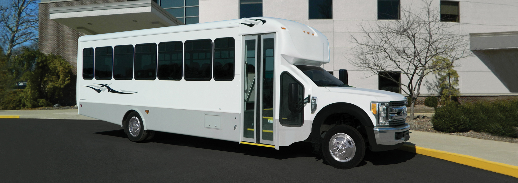 Shuttle bus in front of a brick building